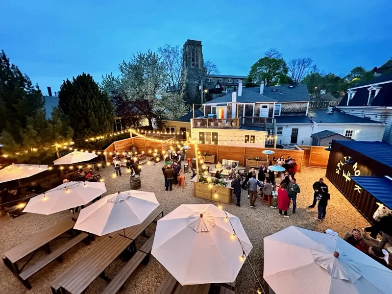 Split Rock beer garden at dusk, string lights glowing over the outdoor patio