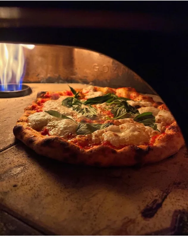 Wood-fired margherita pizza fresh from the oven
